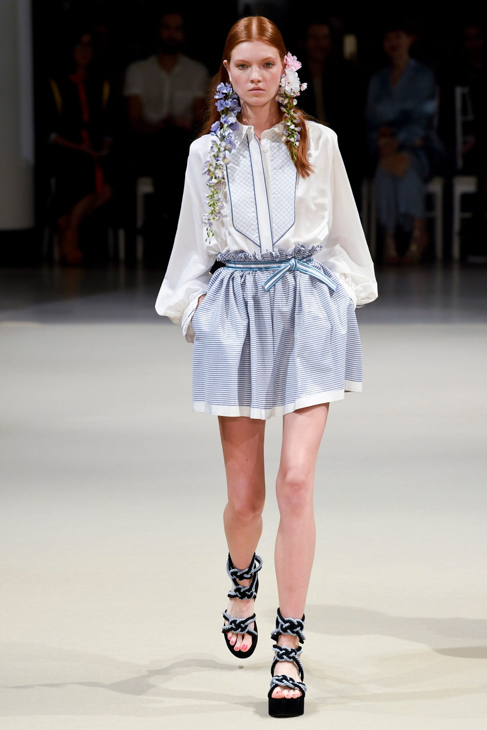 white blouse with blue pleated skirt