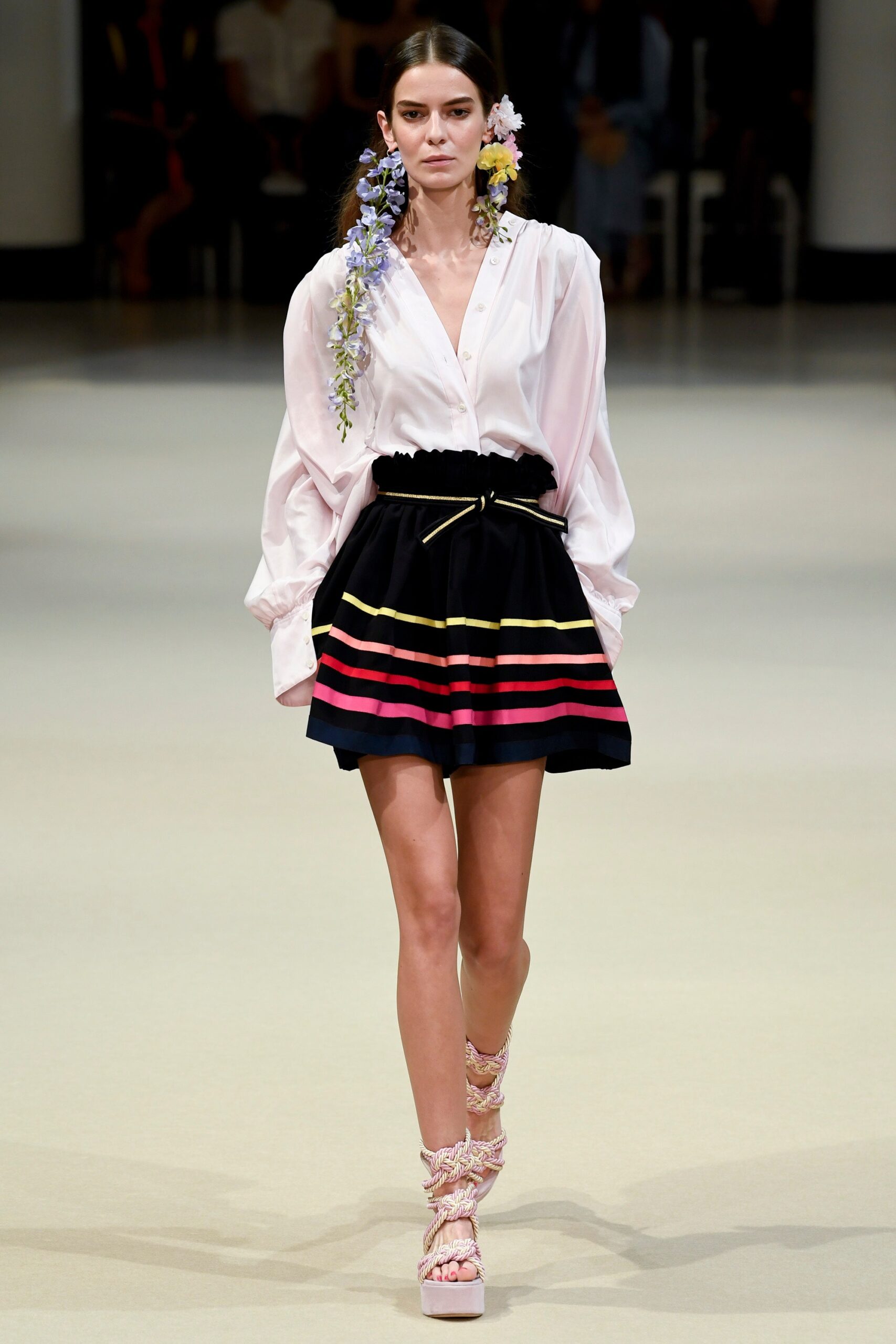 white silk blouse and black pleated skirt