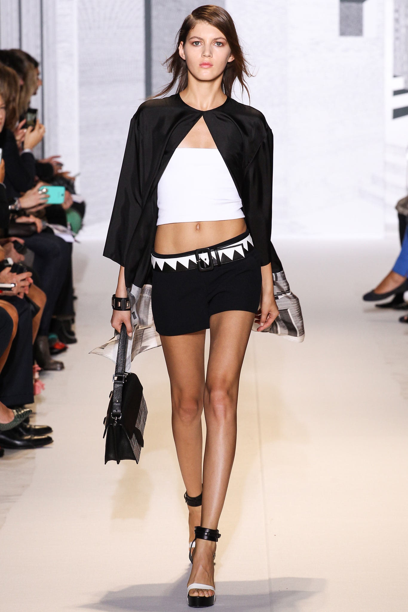 black cape white top black shorts