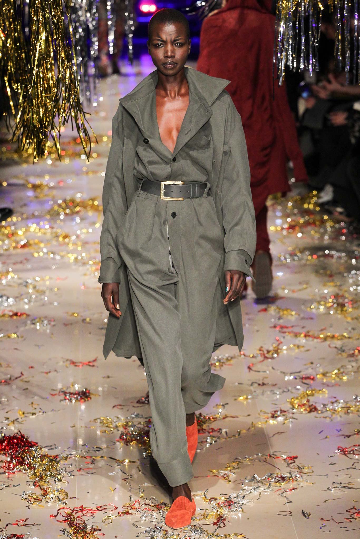 green fitted jumpsuit with orange shoes