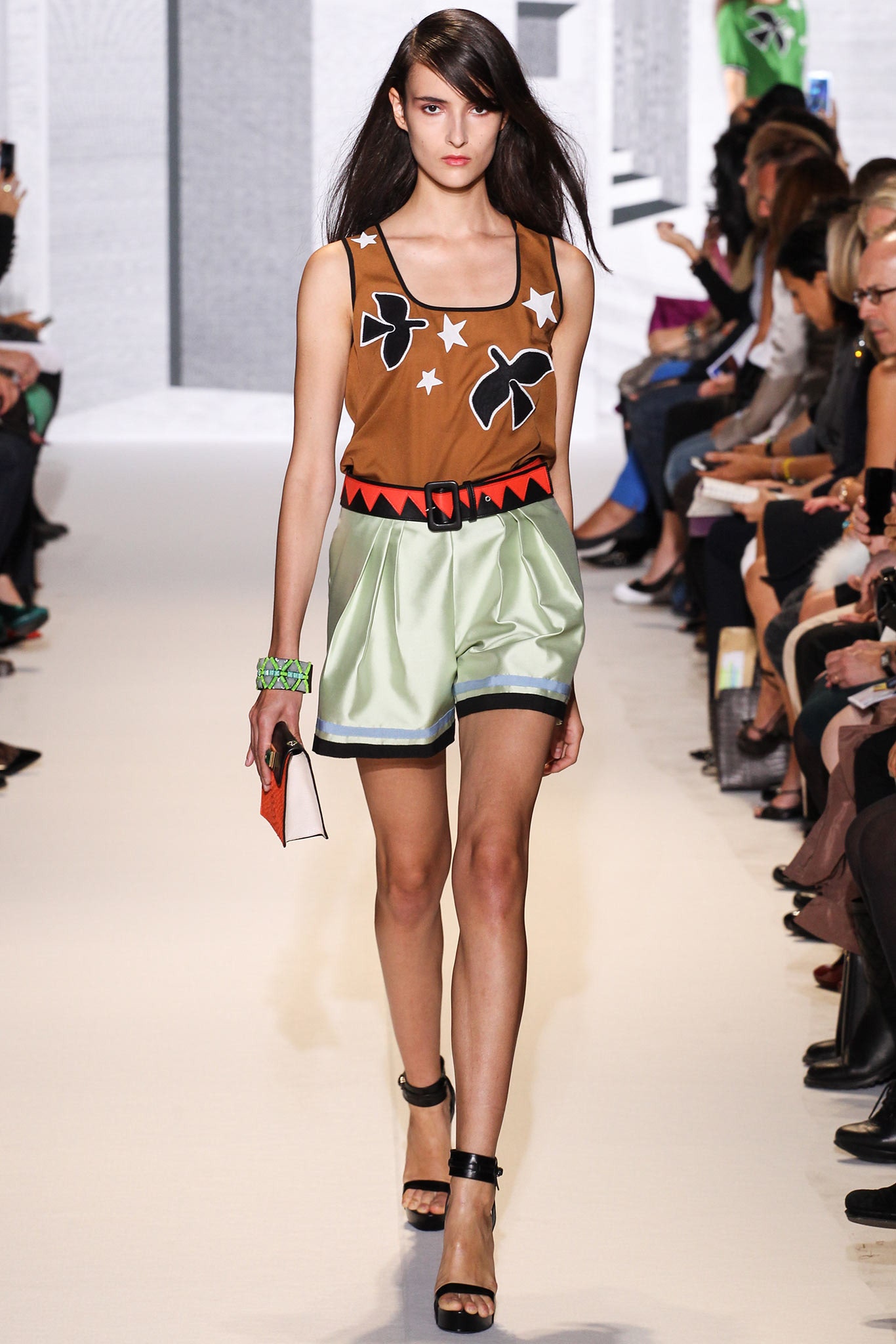 brown printed sleeveless top with green shorts