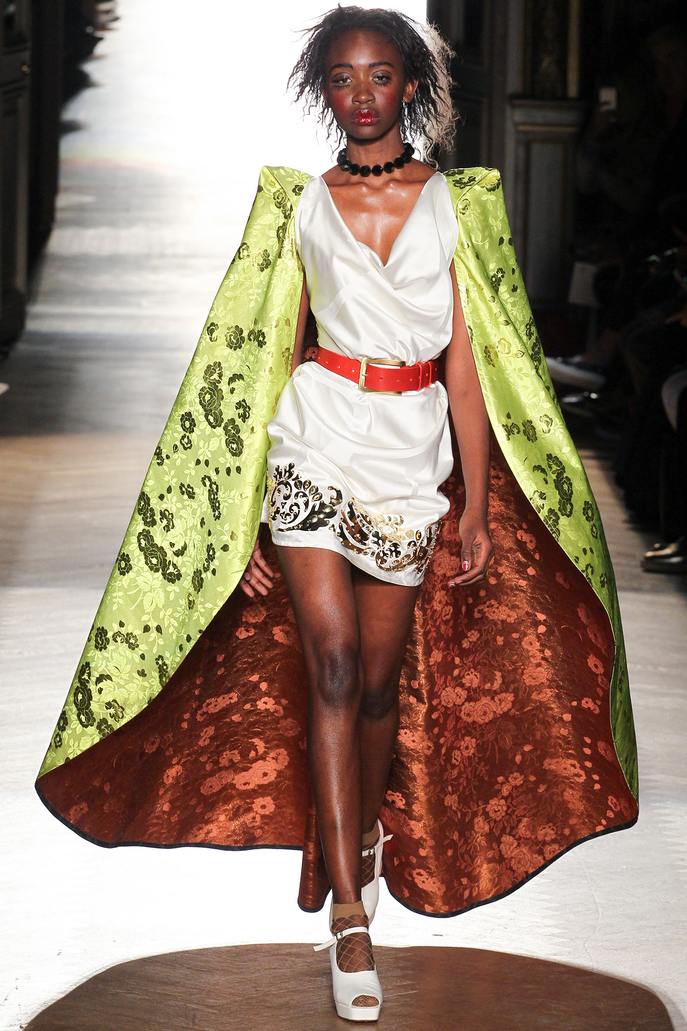 white mini dress with green cape