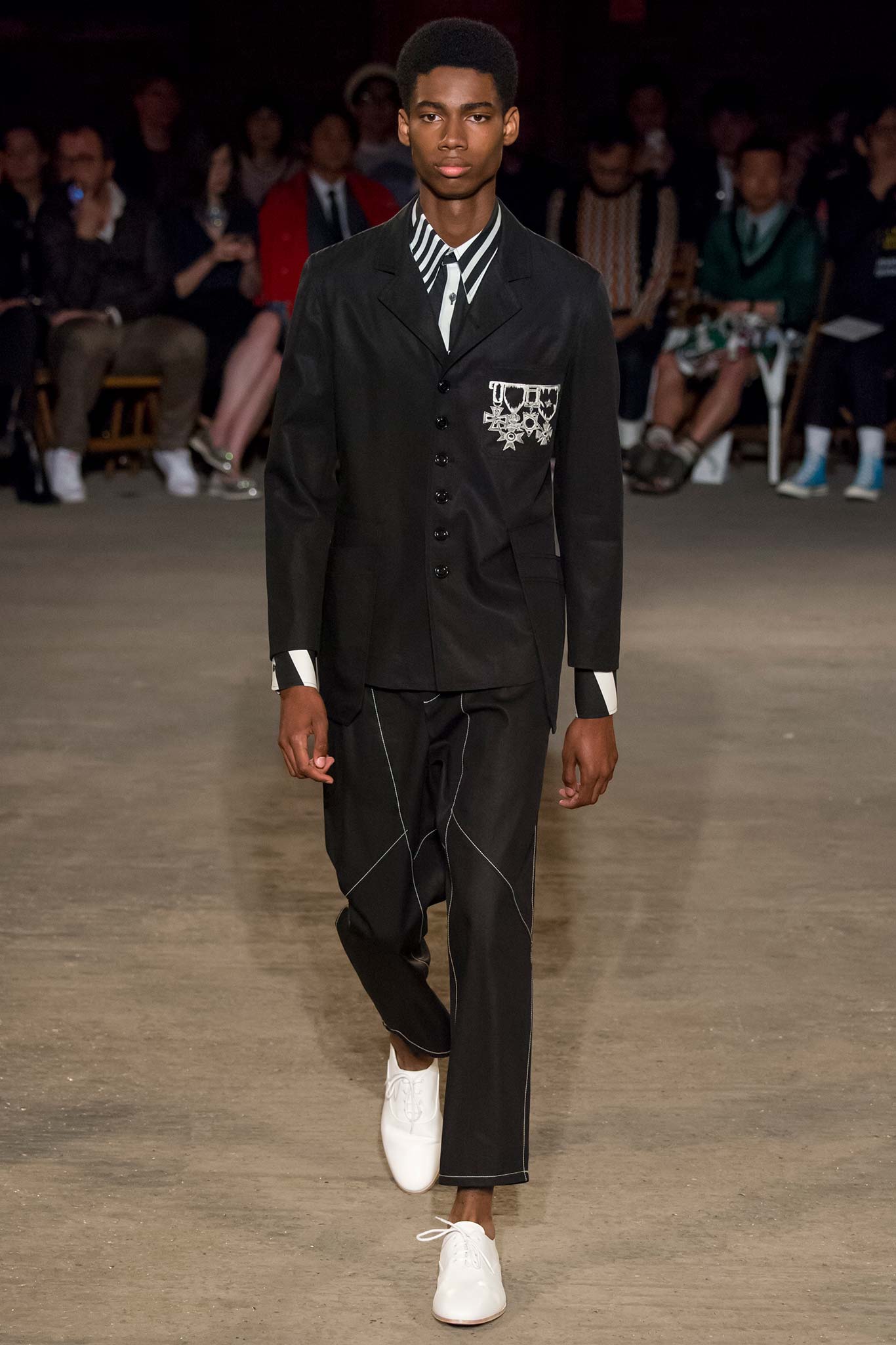black tailored suit with white shoes