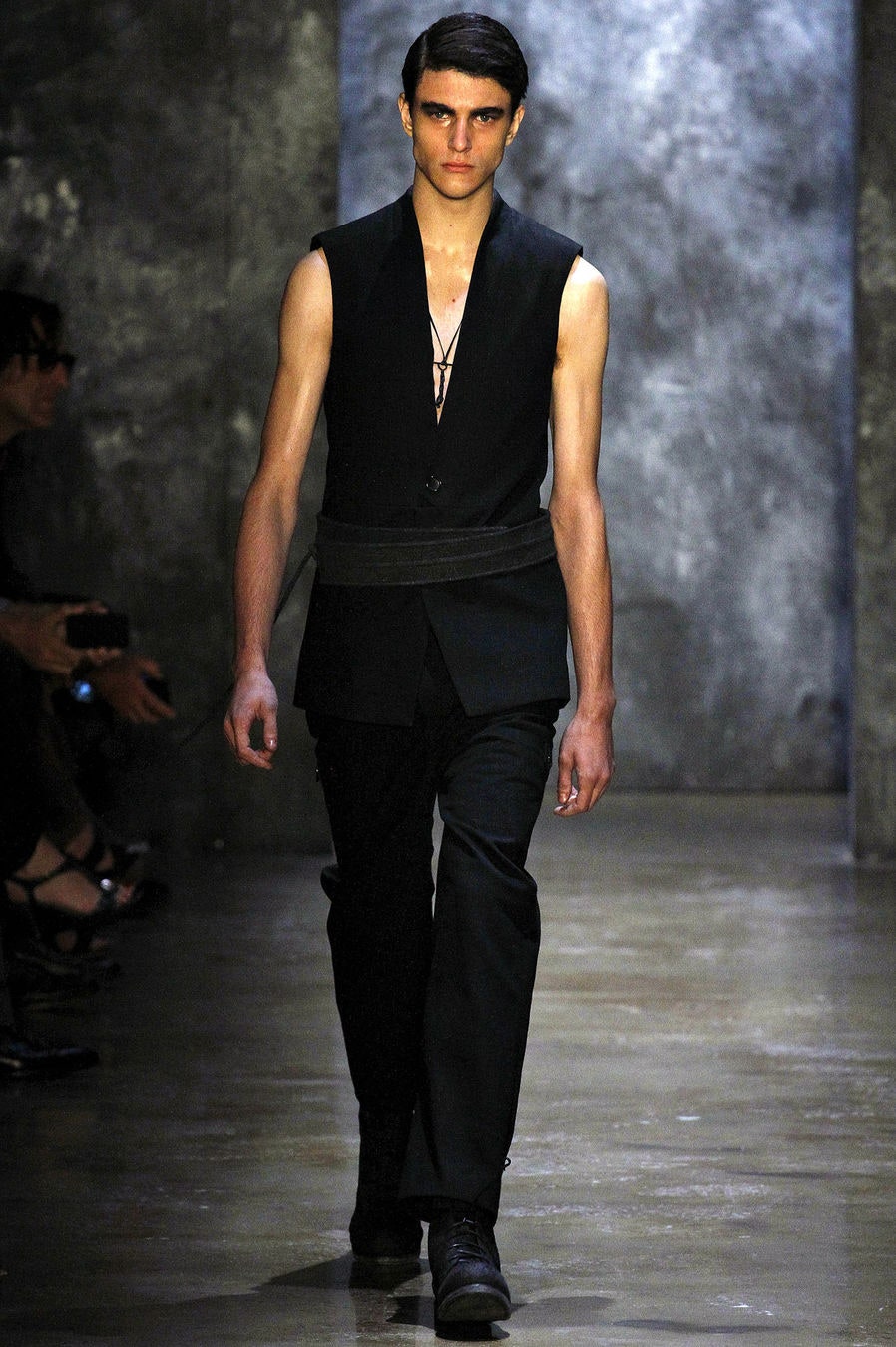 black fitted sleeveless jacket and tailored pants
