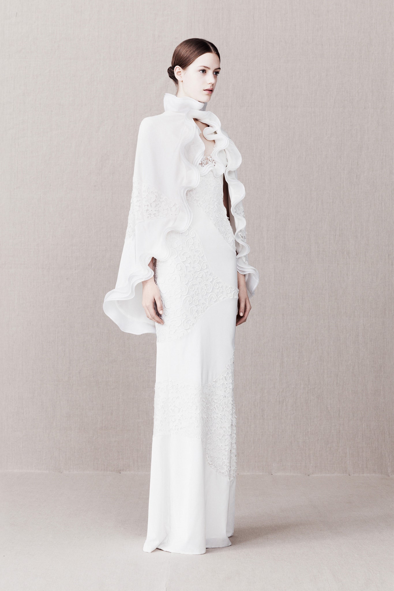 white silk long-sleeve relaxed ruffled flowing cape