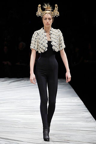 black fitted jumpsuit with white cape