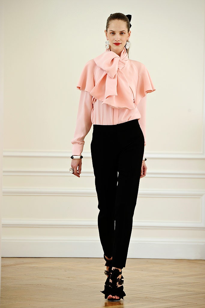 pink ruffled blouse and black pants