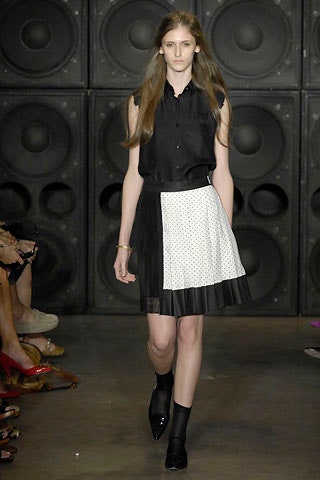black fitted sleeveless top with pleated skirt