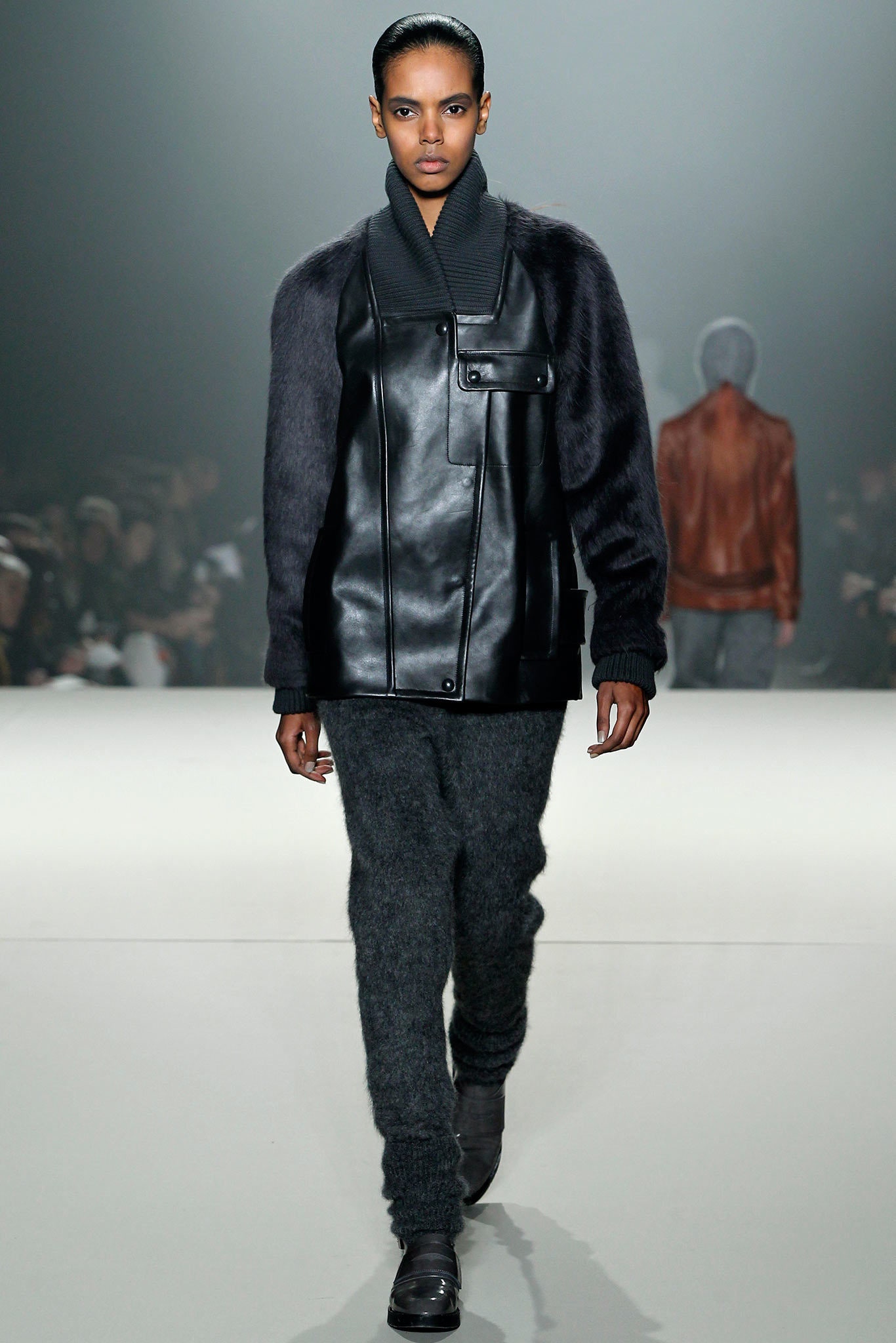 black leather relaxed jacket and gray fitted pants