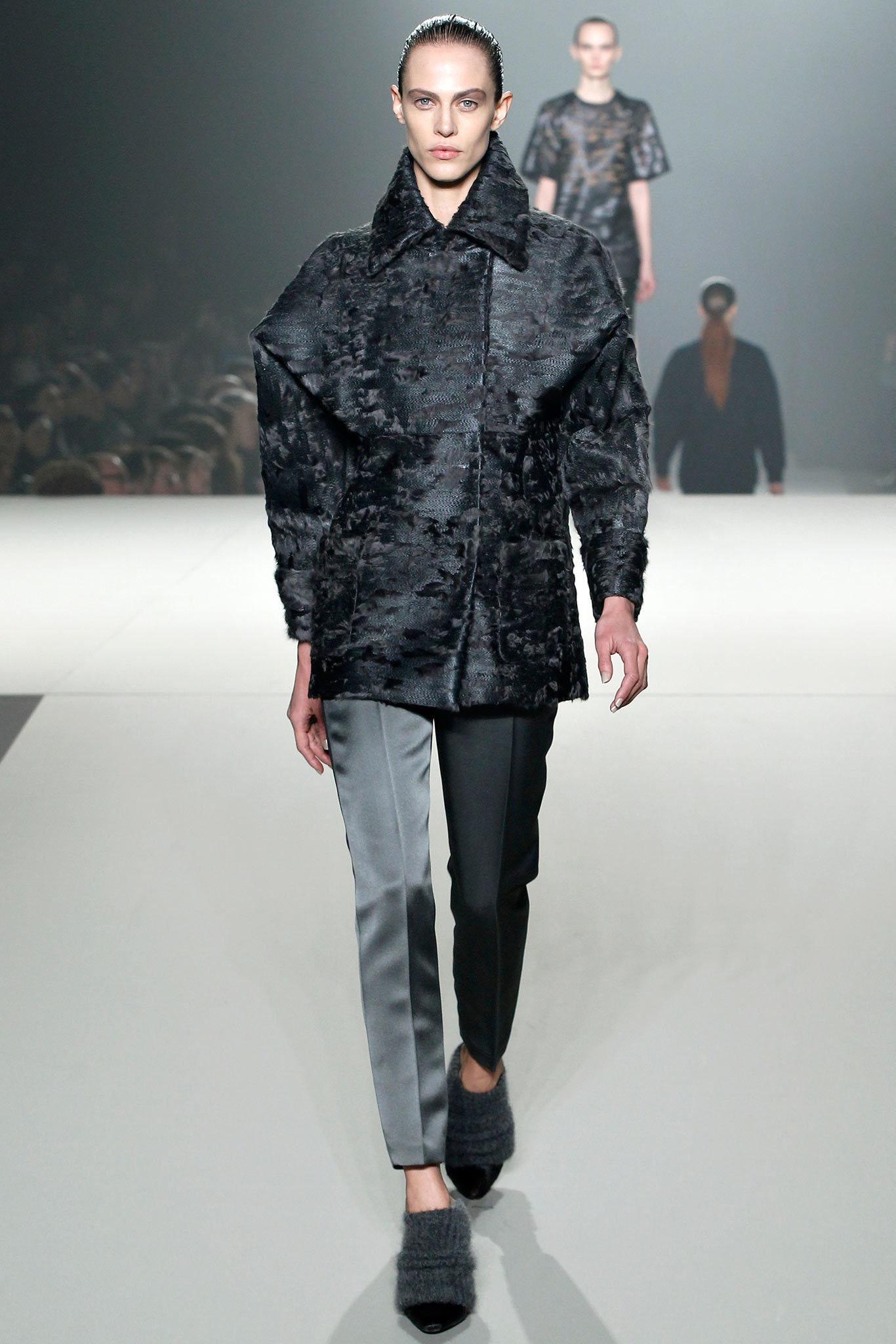 black fur coat and gray pants