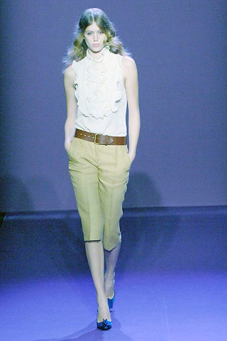 white ruffled top with beige pants