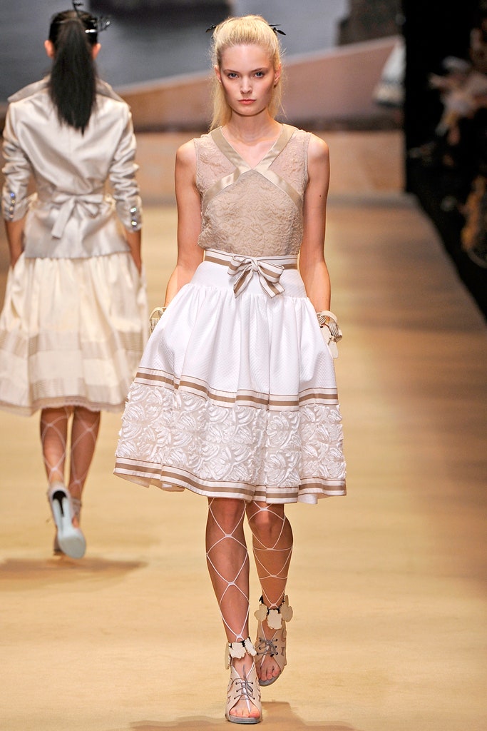 beige lace top and white pleated skirt