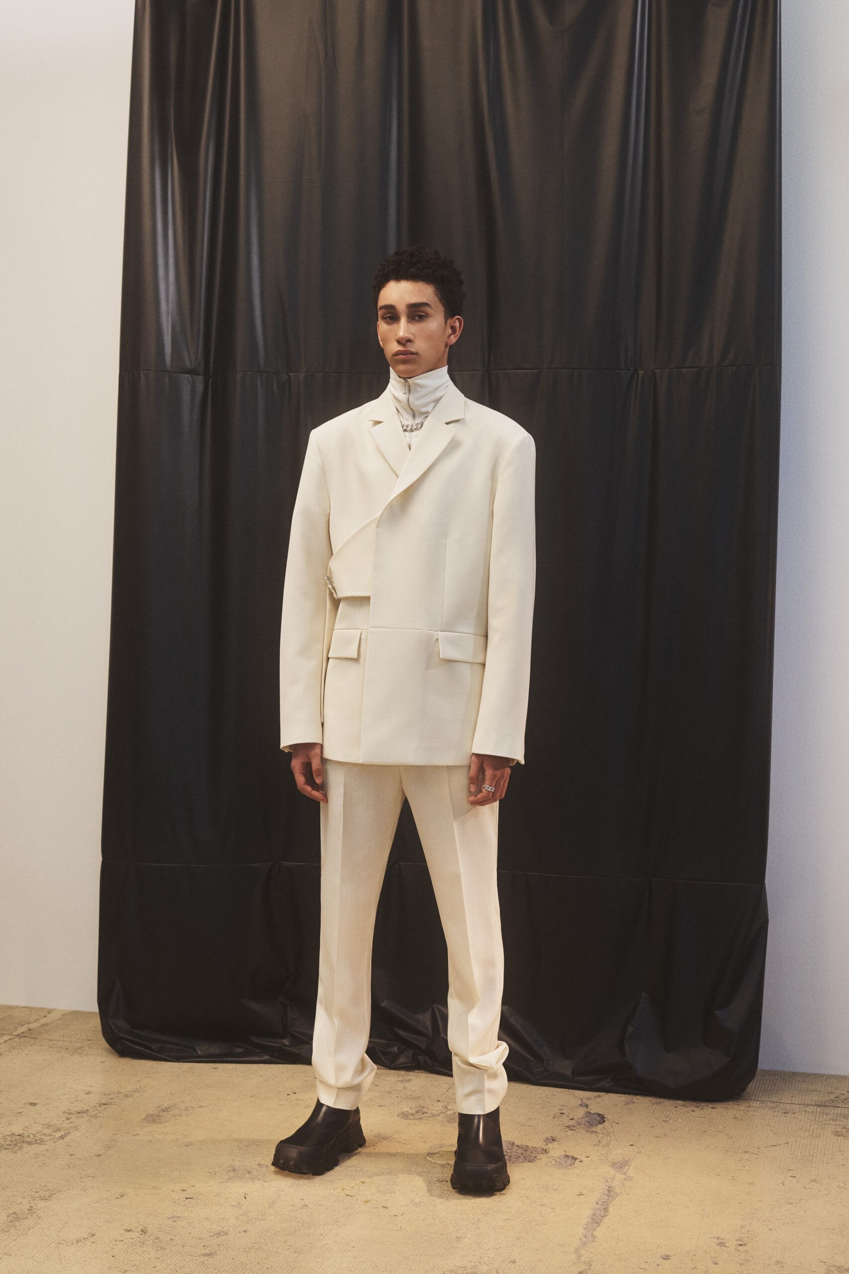 white tailored suit with black shoes