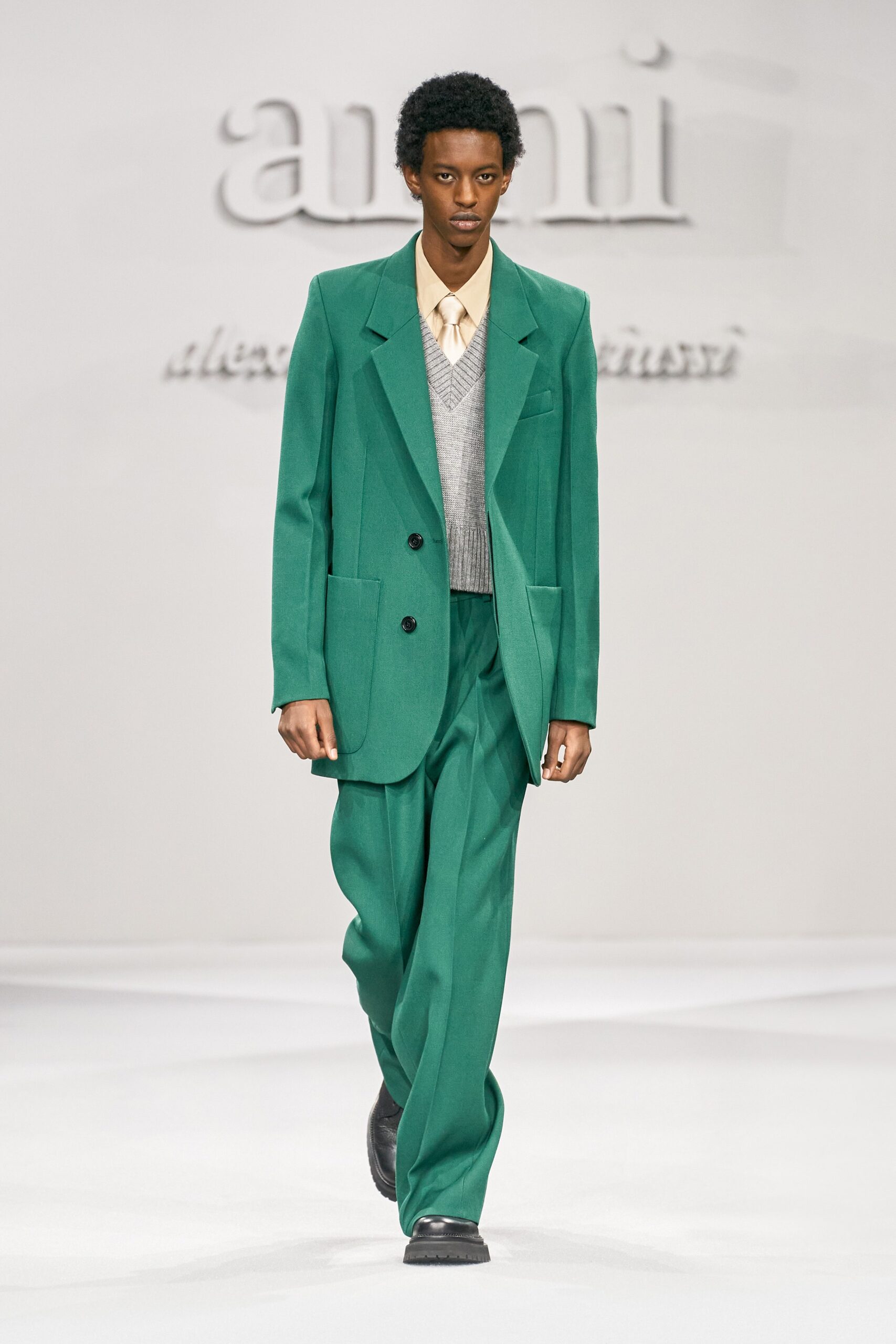 green tailored suit with gray sweater