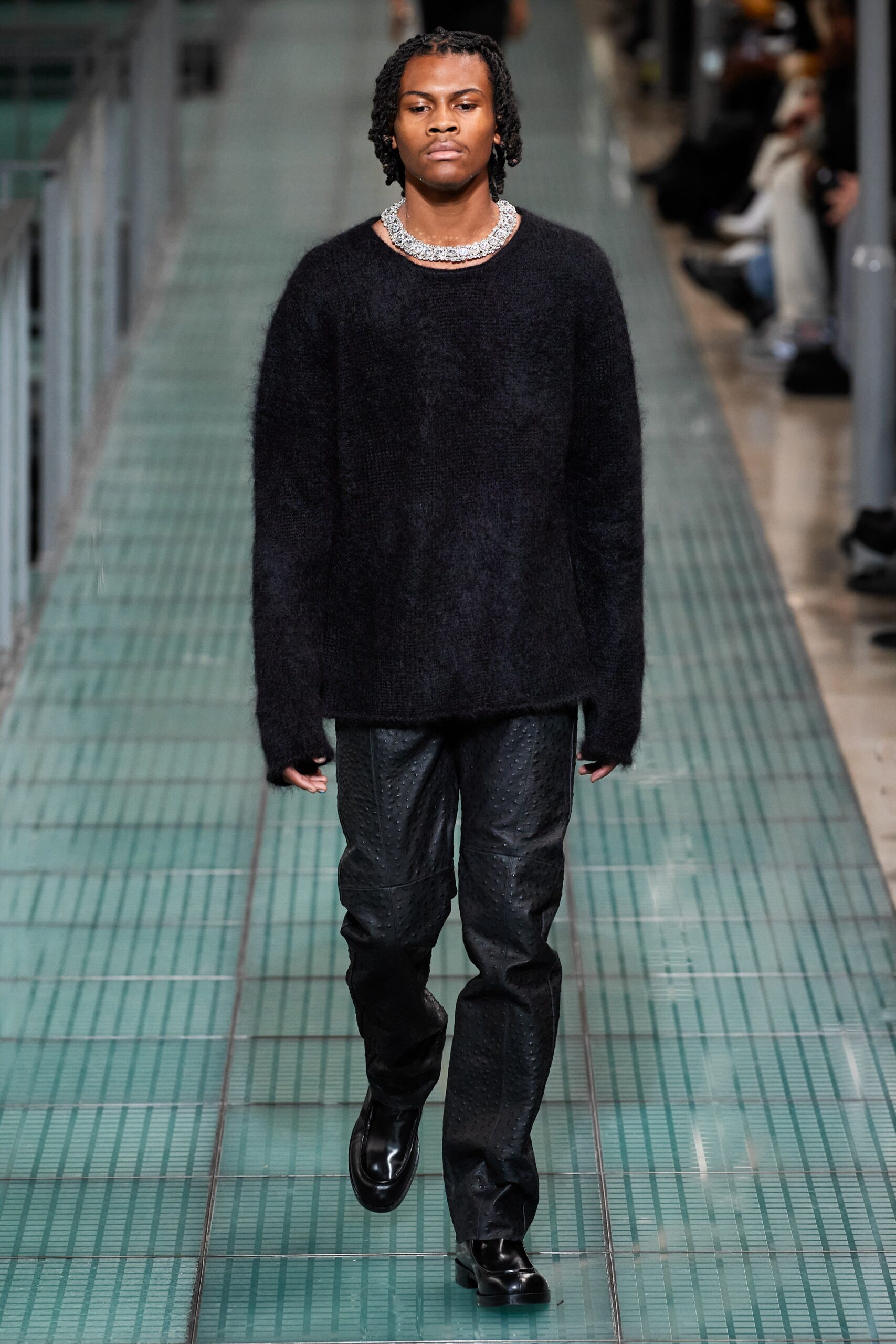 black oversized sweater and leather pants