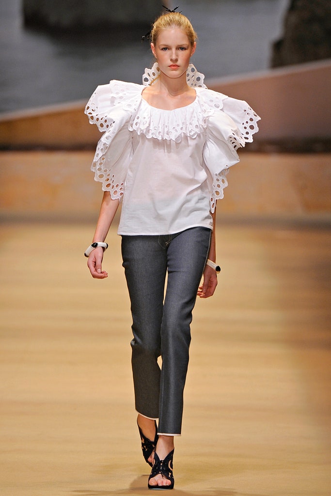 white ruffled top with gray pants