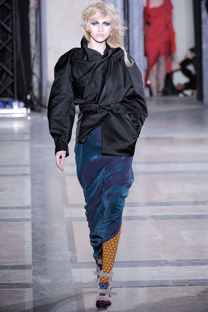 black silk fitted jacket and blue skirt