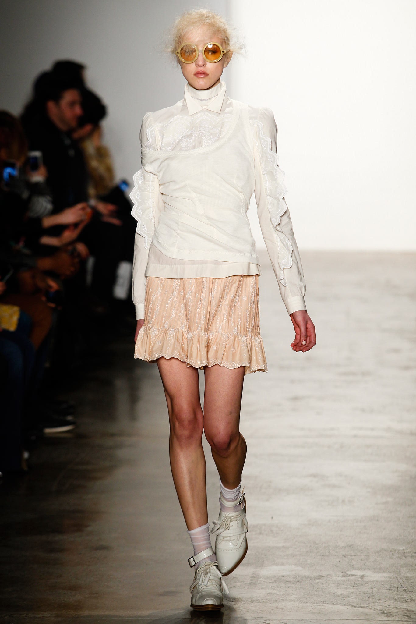 white ruffled blouse with peach skirt