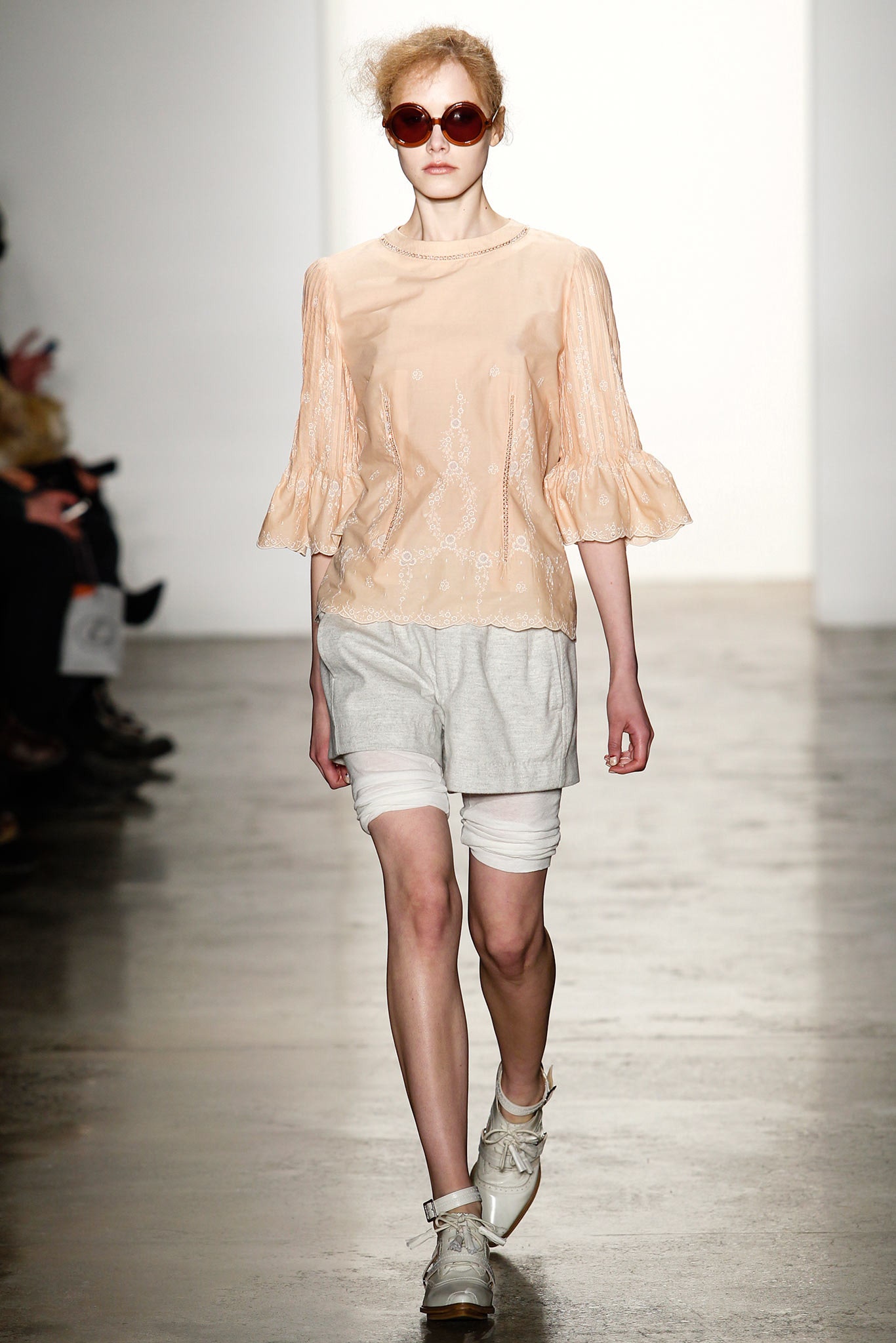 peach embroidered blouse with gray shorts