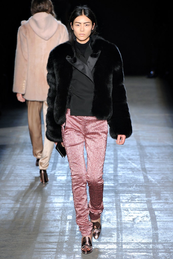 black faux-fur coat and pink pants