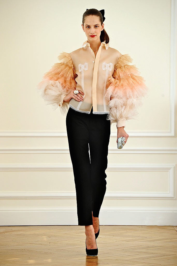 peach ruffled blouse with black pants