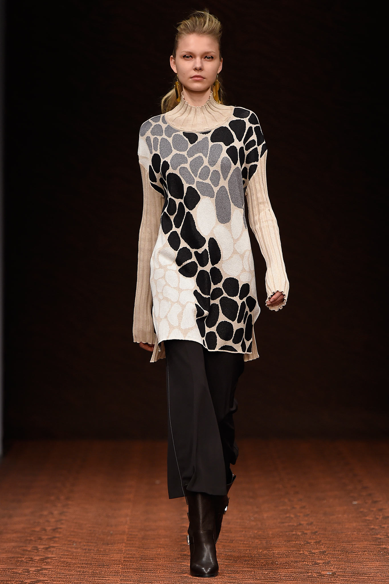beige and black printed top with black pants