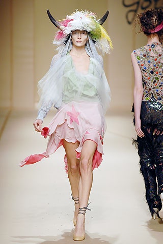 pink and green tiered dress with feathered hat