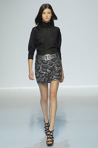 black fitted turtleneck and silver mini skirt