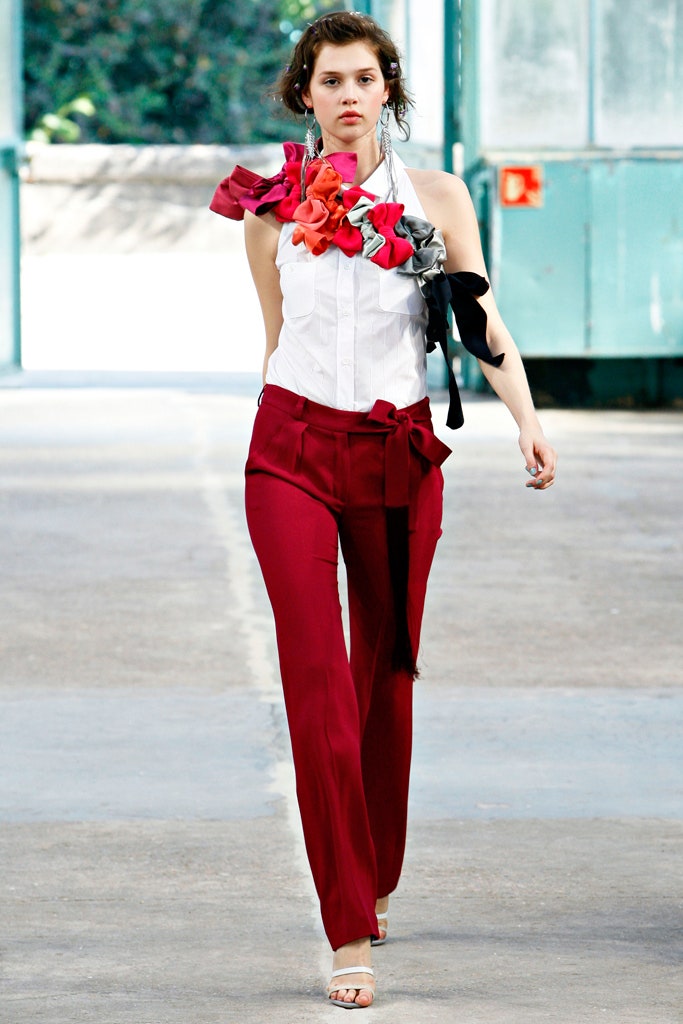 white sleeveless shirt and red tailored pants