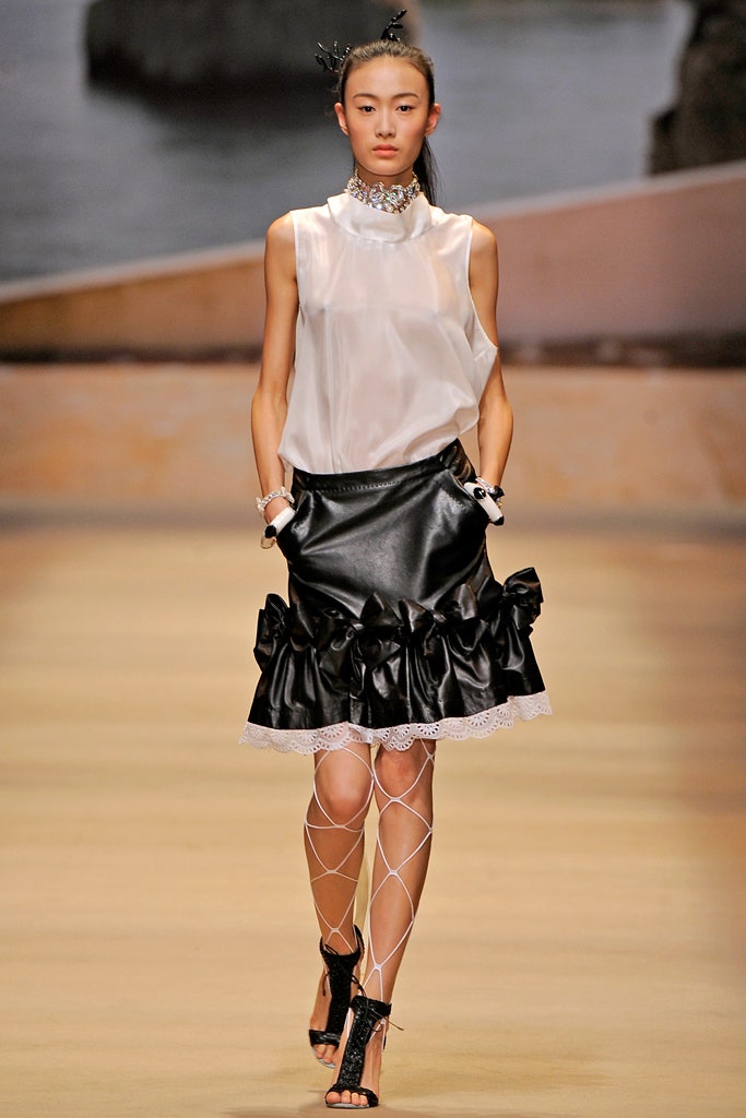 white silk sleeveless top and black leather skirt