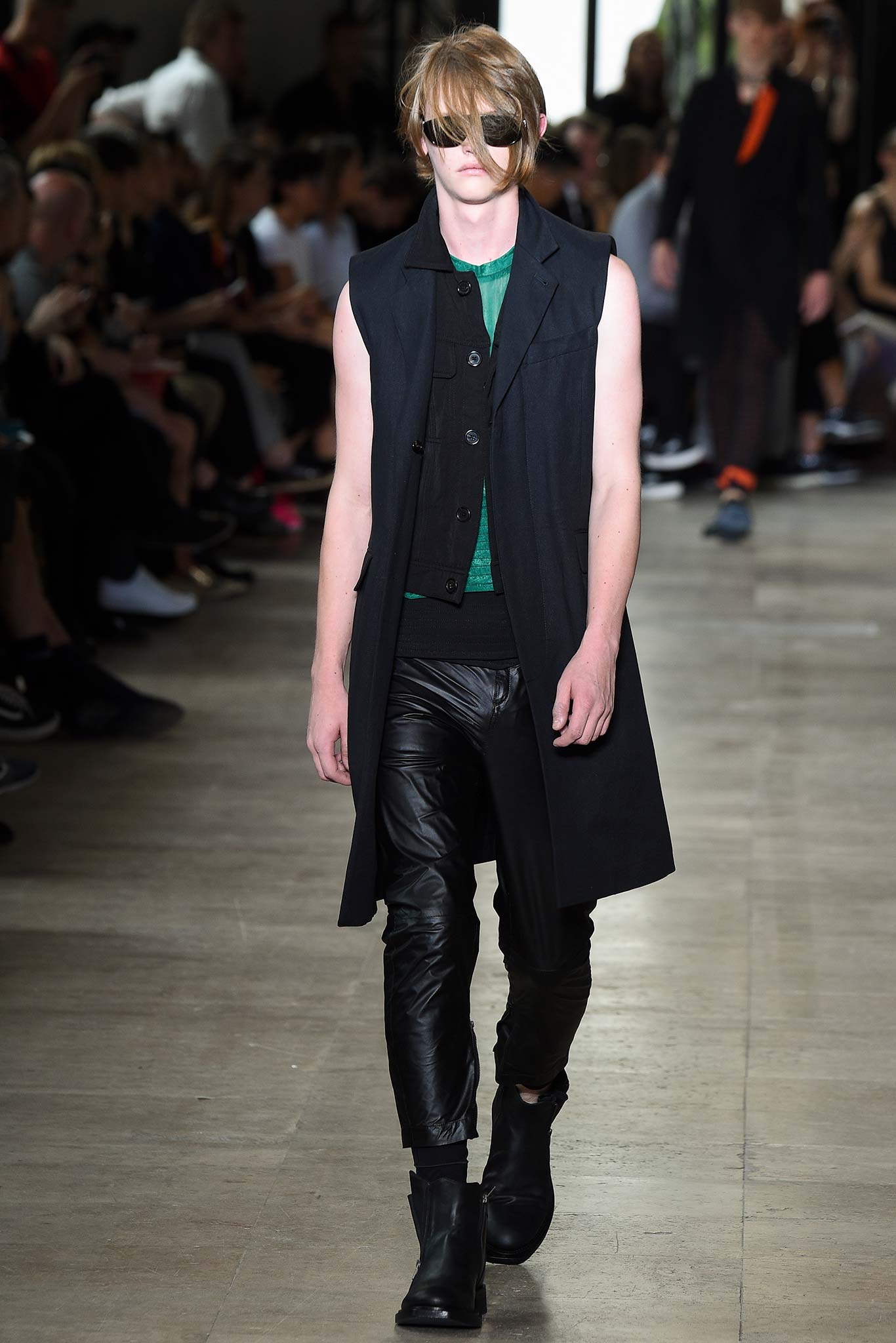 black coat green top leather pants