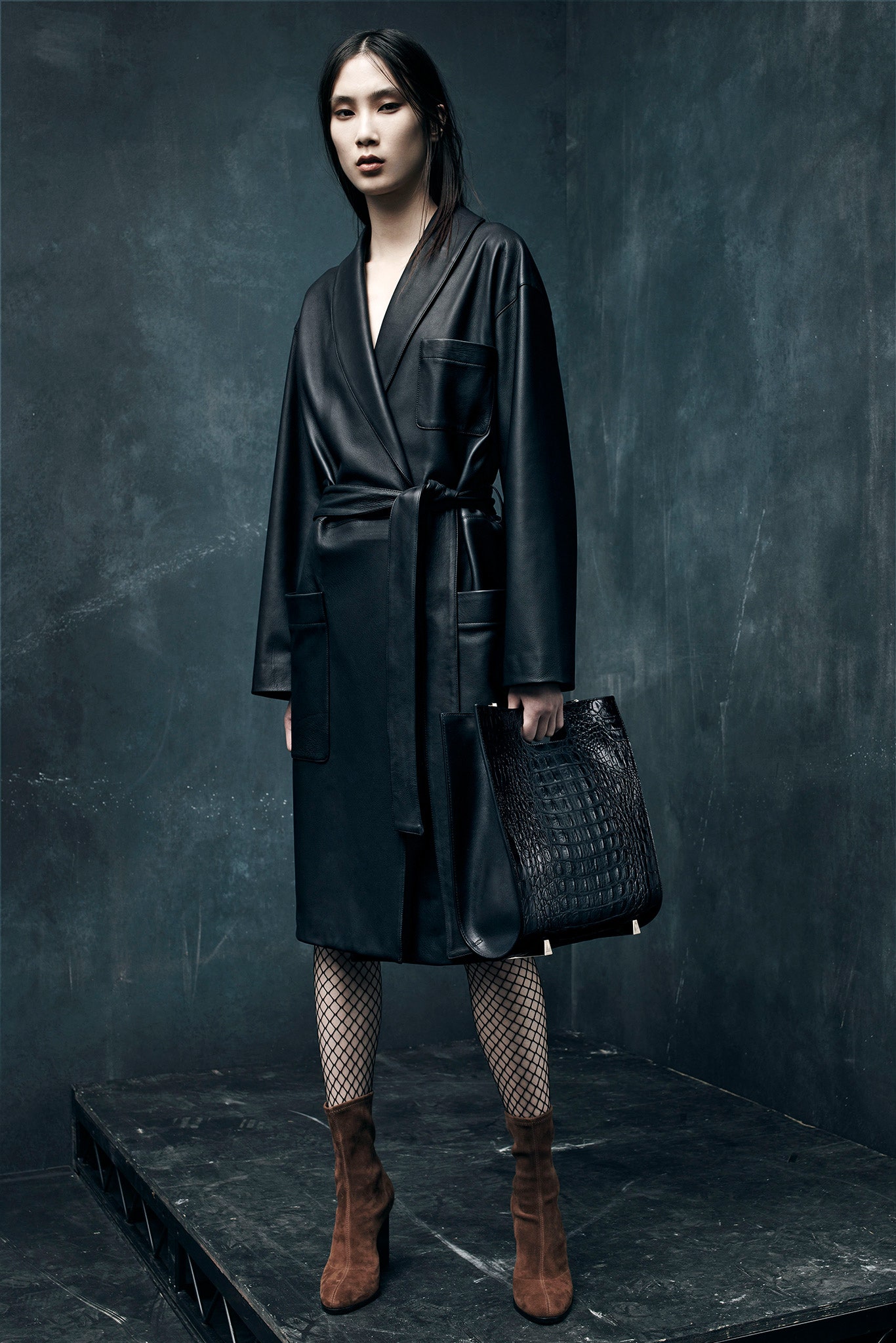 black leather coat with distressed pants