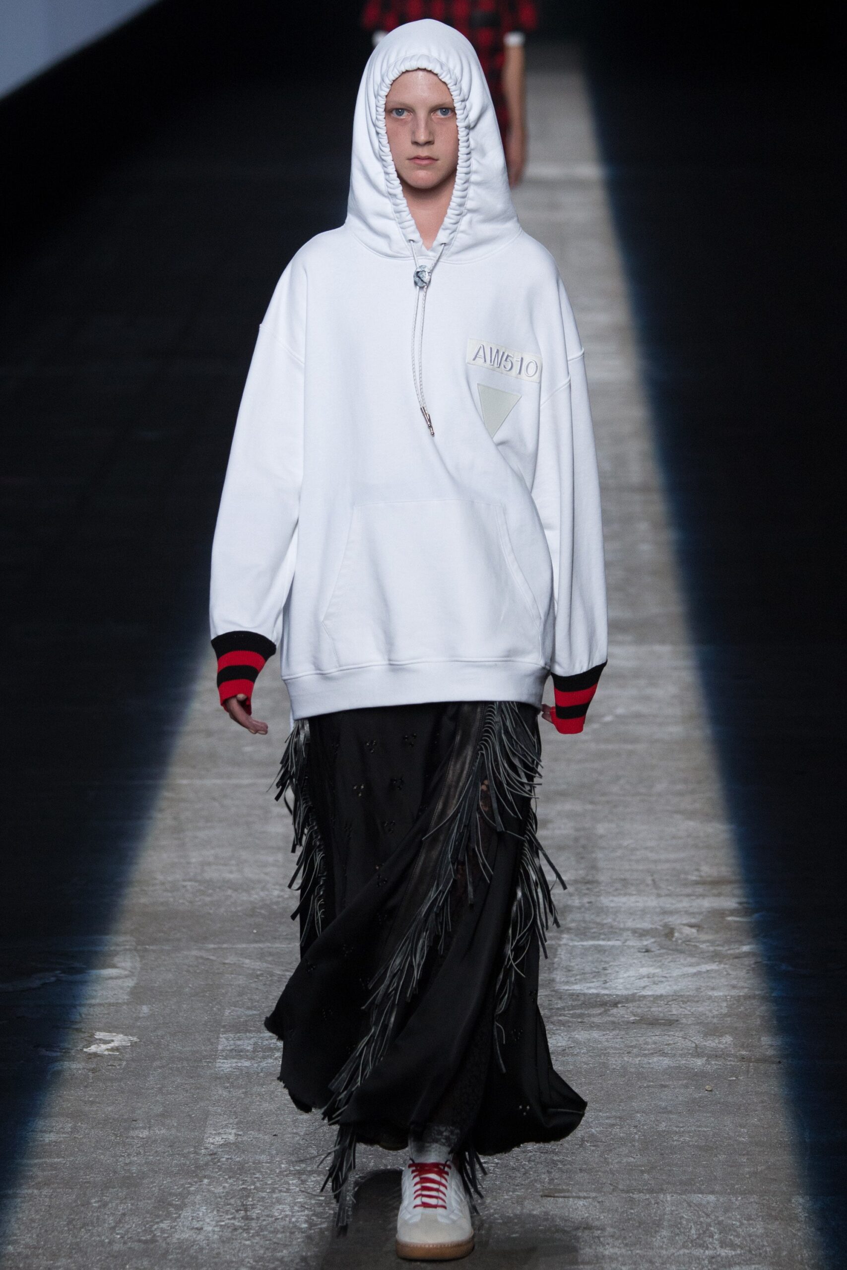 oversized white hoodie and fringed black skirt
