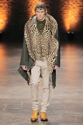 green animal-print poncho with fitted shirt