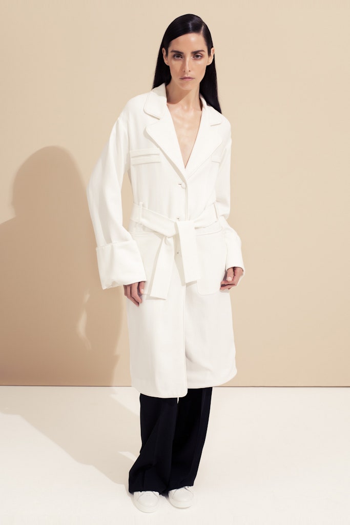 white relaxed coat with black tailored pants