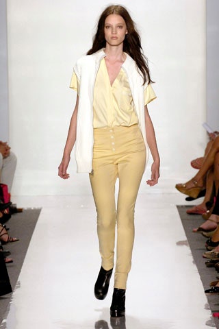 yellow fitted top and pants with white vest