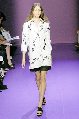 white embroidered coat with black skirt