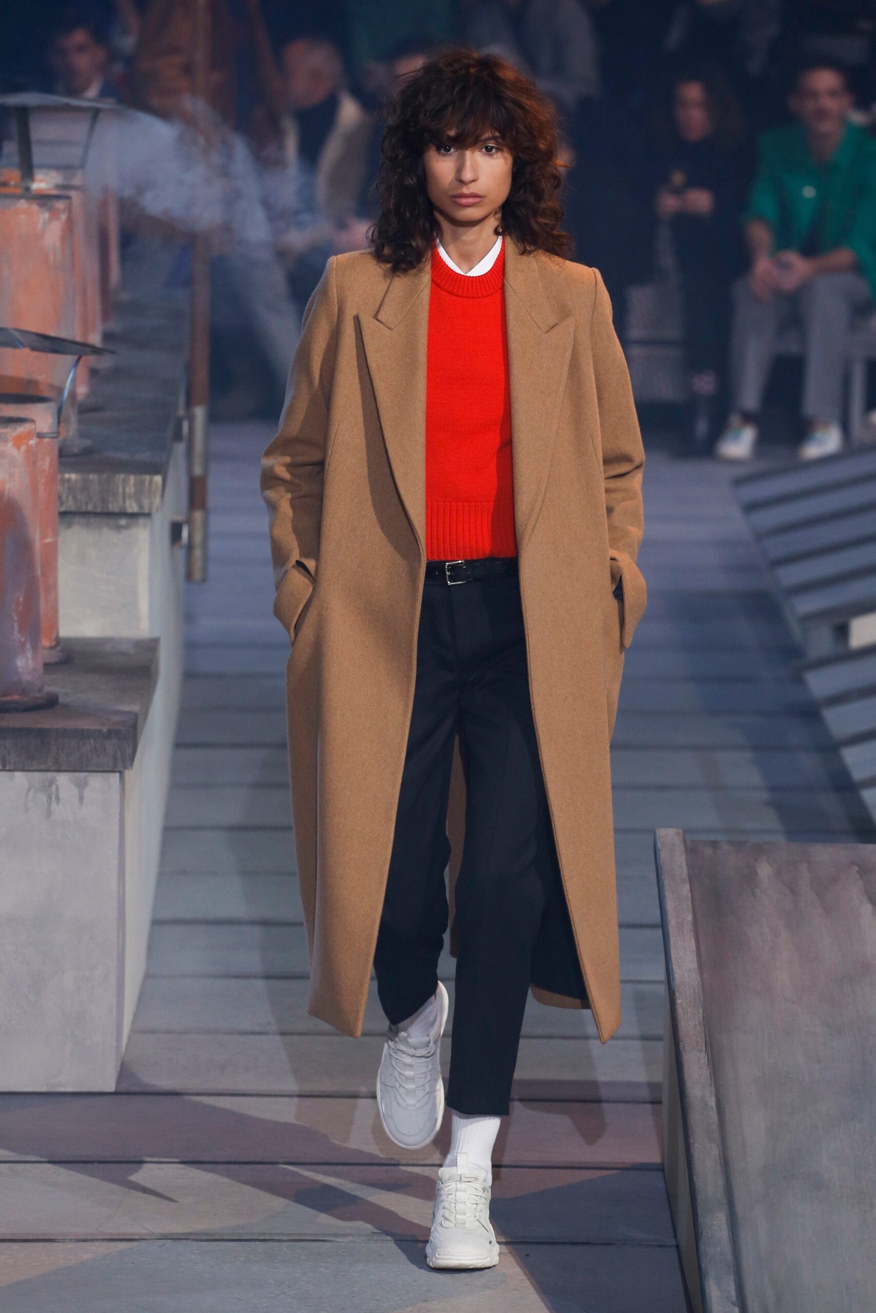 beige coat red sweater black pants