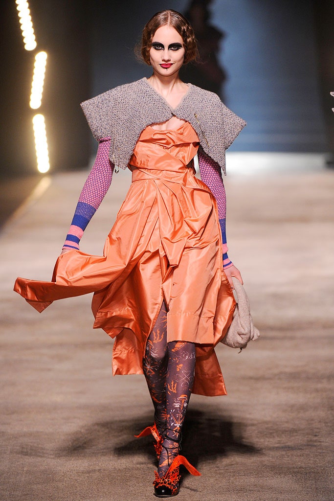 orange silk fitted dress with gray cape