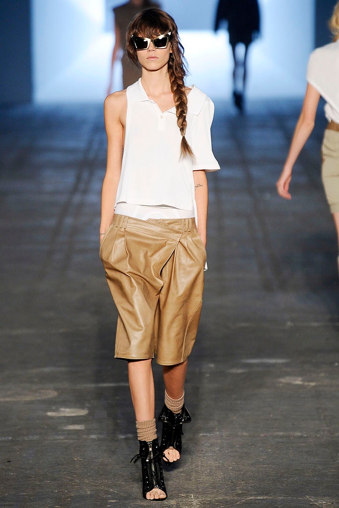 white asymmetric top with beige shorts