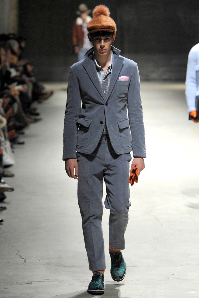 gray tailored suit with orange hat