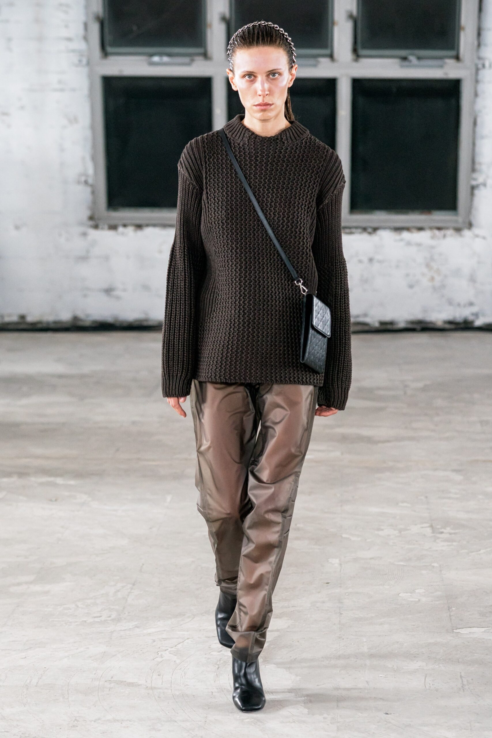 brown knit sweater with gray vinyl pants