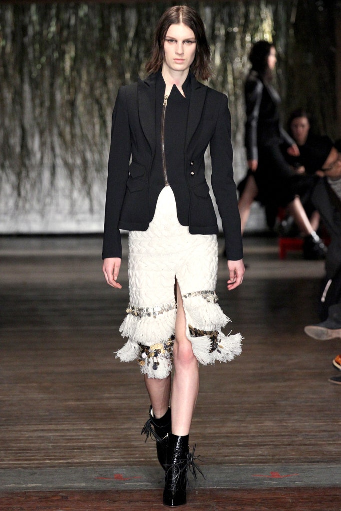 black tailored blazer and white pleated skirt