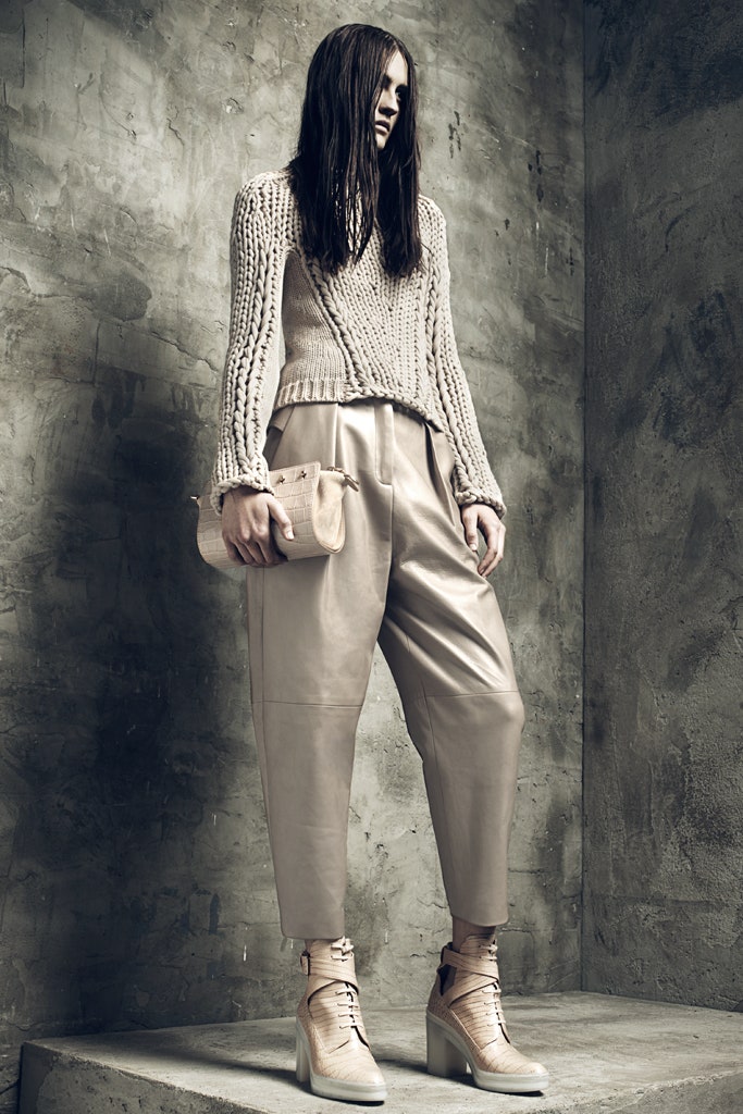 beige wool sweater with gray leather pants