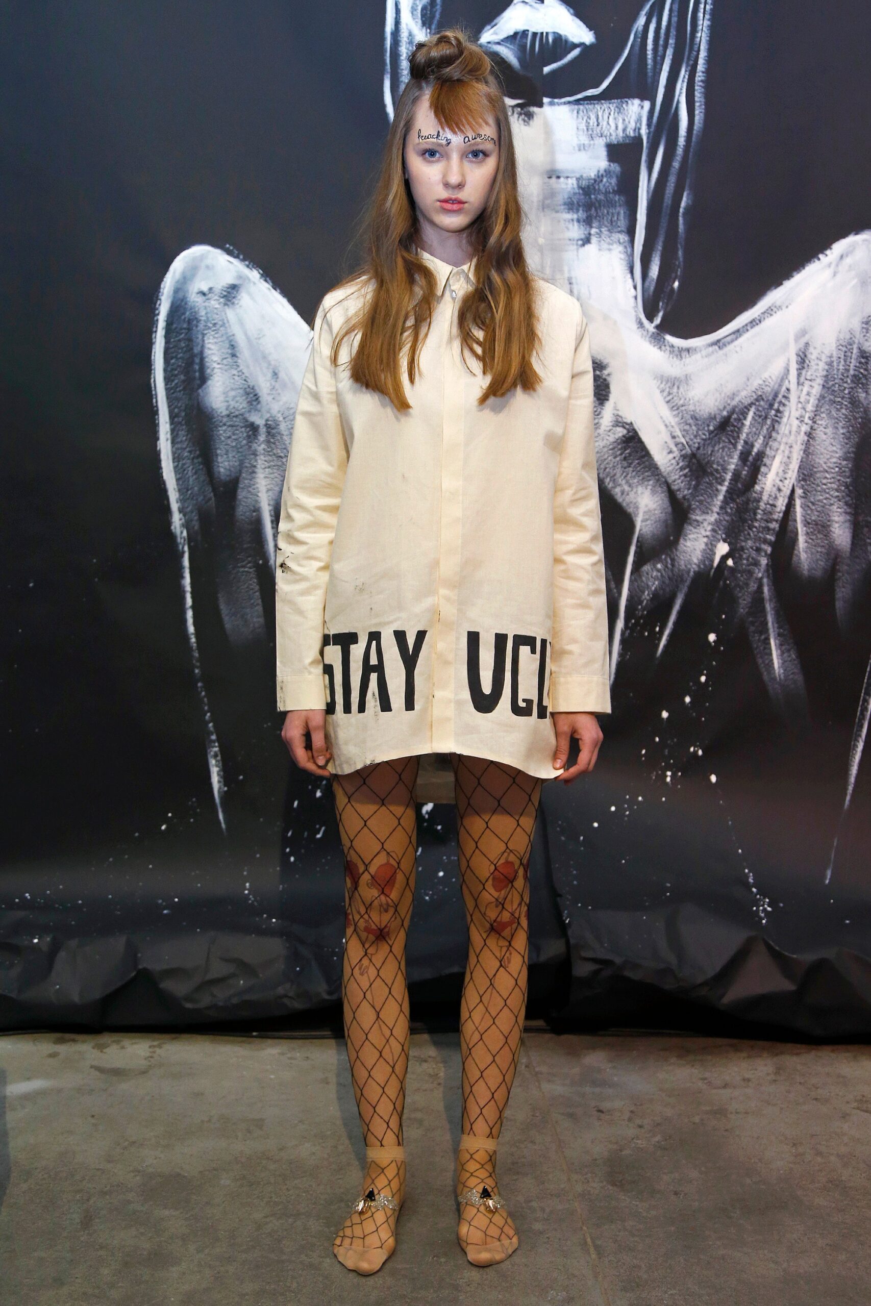 beige shirt-dress with black leggings