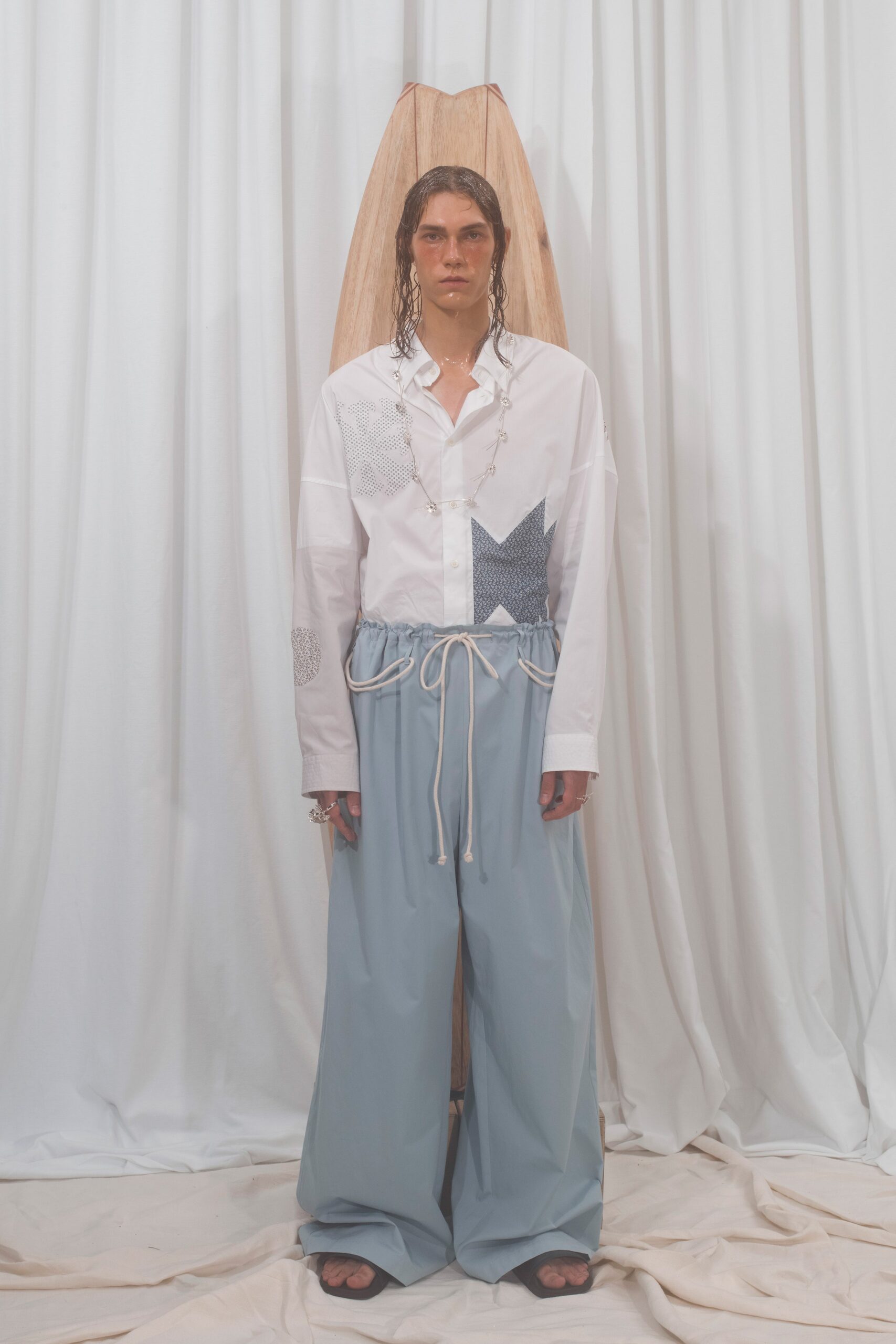 white relaxed shirt and blue pants