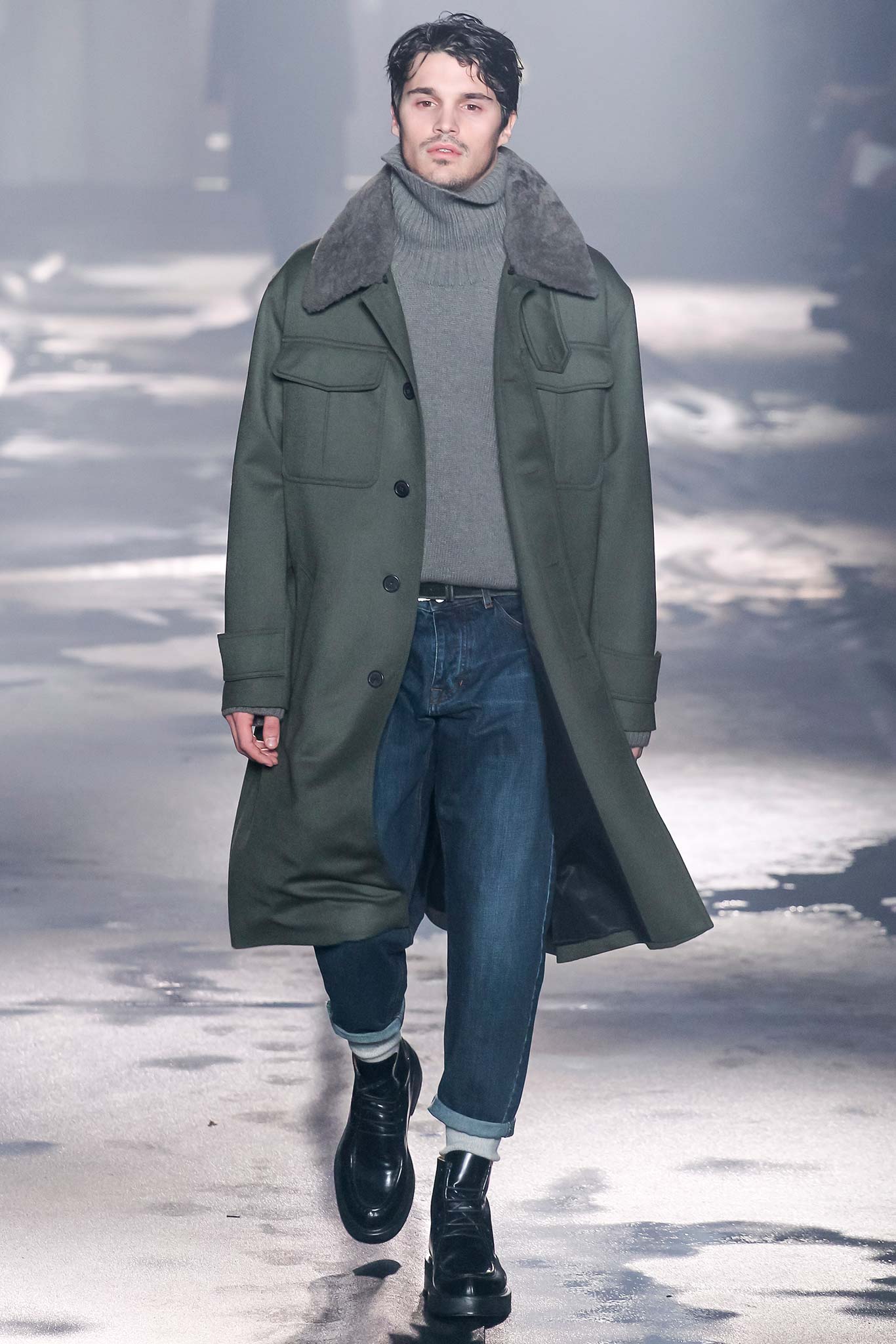 green wool coat gray sweater blue jeans