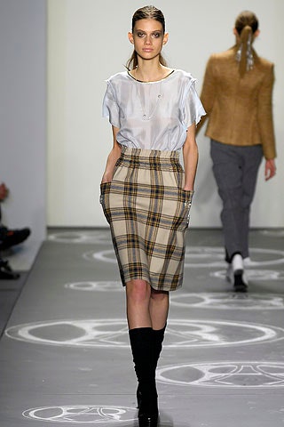 white silk sleeveless top and beige checked skirt