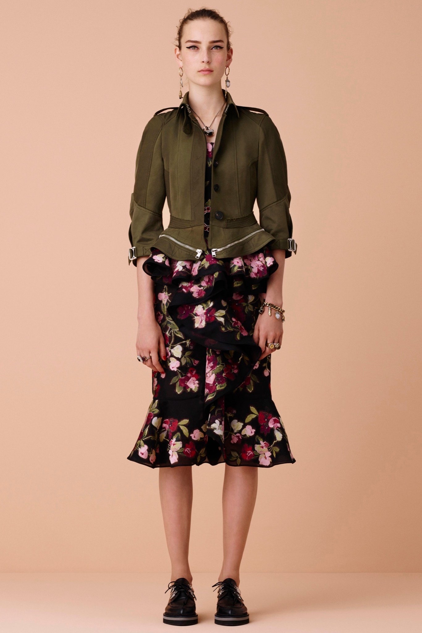 green fitted jacket and black dress