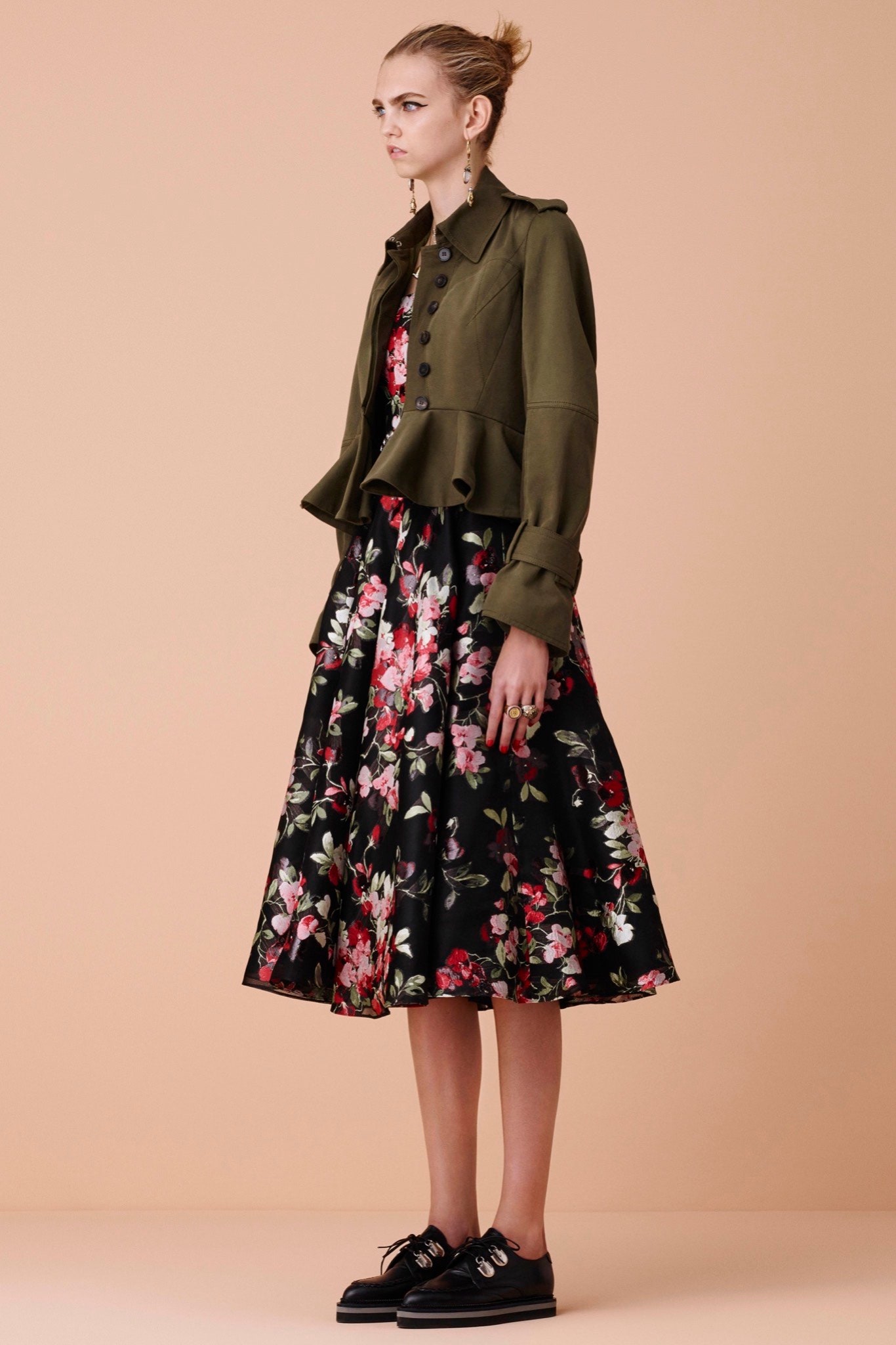 green fitted jacket and black floral dress